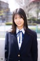 A woman in a school uniform posing for a picture.