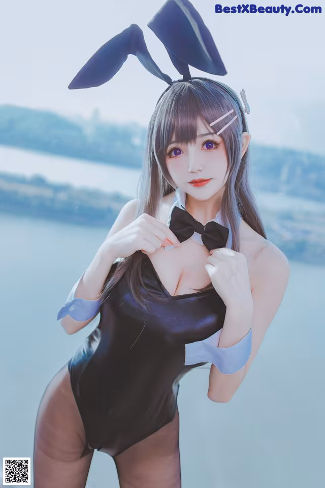 A woman in a bunny costume posing for a picture.