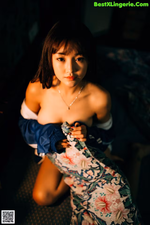 A woman in a blue jacket is posing for a picture.