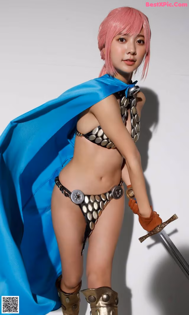 A woman in a bikini holding a sword and a blue cape.