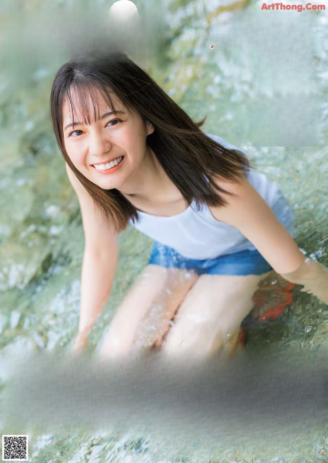 A magazine with a picture of a woman in the water.