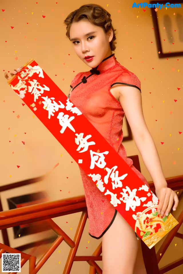 A woman in a red cheongsam holding a red envelope.