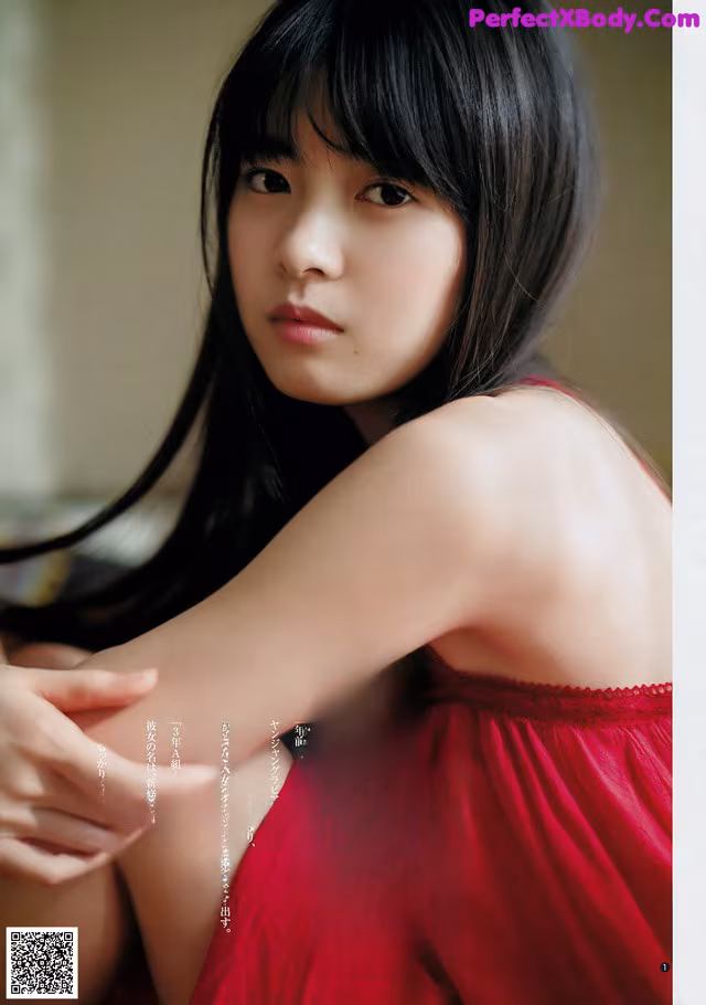 A woman in a red dress is posing for a magazine.
