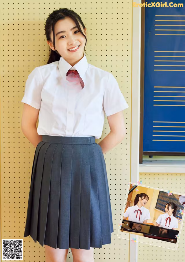 A woman in a school uniform posing for a picture.